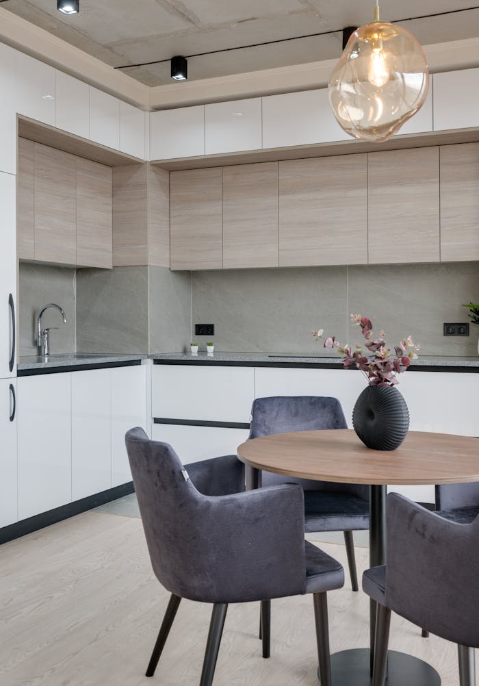 Contemporary kitchen interior with sleek furniture and stylish lighting in a modern apartment.